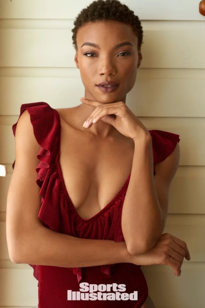 Iyonna Fairbanks poses in a plunging red one-piece swimsuit.